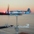 Yak9 stainless steel kinetic wind sculpture spinning on a seaside terrace at sunrise
