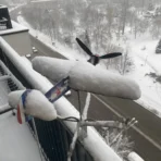 Yak9 weatherproof outdoor weathervane on the balcony after snowfall