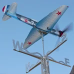 Outdoor installation of a Yak9 WWII fighter airplane weathervane and kinetic wind spinner