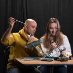 Father and teenager daughter building Marseille Bf109F4 airplane weathervane prefabricated construction set