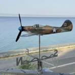 Coastal resistant Bell P39 Airacobra weathervane DIY gift kit installed on a balcony against a seaside