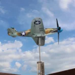 Bell P39 Airacobra stainless steel aircraft model operating as weathervane and wind spinner against a cloudy sky