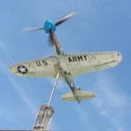 View from below of a P39 Airacobra fighter model functioning as a kinetic wind spinner